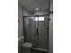 Bathroom highlighting a glass-enclosed shower with marble-look tiling and dual shower heads at 508 Bennett St, Auburndale, FL 33823
