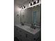 Bathroom featuring a dual sink vanity with matte black fixtures, and modern lighting at 508 Bennett St, Auburndale, FL 33823