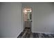 Bathroom featuring a dual sink vanity with dark fixtures, wood-look flooring, and a framed mirror at 508 Bennett St, Auburndale, FL 33823