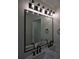 Bathroom showcasing dual sinks, matte black fixtures, and vanity lights at 508 Bennett St, Auburndale, FL 33823