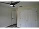 This bedroom features a ceiling fan, closet, and modern flooring at 508 Bennett St, Auburndale, FL 33823