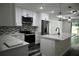 Modern kitchen features white cabinets, stainless steel appliances, and quartz countertops at 508 Bennett St, Auburndale, FL 33823