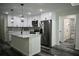 Bright kitchen with white cabinets, stainless steel refrigerator, and kitchen island at 508 Bennett St, Auburndale, FL 33823