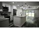 This modern kitchen features an island and stainless-steel appliances at 508 Bennett St, Auburndale, FL 33823