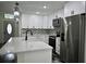 Modern kitchen features white cabinetry, stainless steel appliances, and a stylish backsplash at 508 Bennett St, Auburndale, FL 33823
