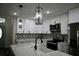 Well-lit kitchen with stainless steel appliances, modern countertops, and attractive tile backsplash at 508 Bennett St, Auburndale, FL 33823