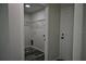Laundry room with gray floors, wire shelves, and washer/dryer hookups at 508 Bennett St, Auburndale, FL 33823