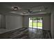 Spacious living room with recessed lights, ceiling fan, wood floors, and sliding glass doors at 508 Bennett St, Auburndale, FL 33823