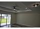 Bright living room featuring a modern ceiling fan, recessed lighting, and sliding glass doors to the backyard at 508 Bennett St, Auburndale, FL 33823