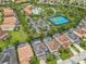 Aerial view of a residential area with community pool, tennis courts, and well-maintained properties at 5255 Wildwood Way, Davenport, FL 33837