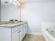 Bright bathroom with large mirror, double sinks, and soaking tub at 5255 Wildwood Way, Davenport, FL 33837