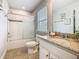 Bright bathroom featuring a shower-tub combo and vanity with granite countertop at 5255 Wildwood Way, Davenport, FL 33837