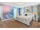 Bright bedroom featuring a custom accent wall, plush bedding, and an ensuite bathroom at 5255 Wildwood Way, Davenport, FL 33837