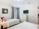 Bright bedroom with twin beds and TV at 5255 Wildwood Way, Davenport, FL 33837