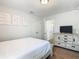 Bright bedroom with twin beds and a chest of drawers for storage at 5255 Wildwood Way, Davenport, FL 33837