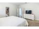 Bright bedroom featuring a comfortable bed, modern dresser, and neutral decor, creating a serene and inviting space at 5255 Wildwood Way, Davenport, FL 33837