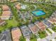 Aerial view featuring a community pool, tennis courts, parking, and well-maintained landscaping at 5255 Wildwood Way, Davenport, FL 33837