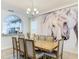Dining room with wooden table, chairs, chandelier, and a striking horse mural on the wall at 5255 Wildwood Way, Davenport, FL 33837