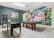 Spacious game room with mural wall, perfect for Gathering entertainment at 5255 Wildwood Way, Davenport, FL 33837