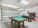 Spacious garage game room with pool table and foosball table for recreation at 5255 Wildwood Way, Davenport, FL 33837