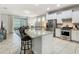 Open kitchen featuring stainless steel appliances, white cabinets, granite counters, and access to the patio at 5255 Wildwood Way, Davenport, FL 33837