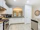 Bright and modern kitchen with granite countertops, stainless steel appliances, and white cabinets at 5255 Wildwood Way, Davenport, FL 33837