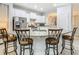 Kitchen with white cabinets, granite countertops, stainless steel appliances, and breakfast bar seating at 5255 Wildwood Way, Davenport, FL 33837
