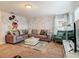 Playful living room with custom Mickey Mouse mural, comfortable seating, and a bright, inviting atmosphere at 5255 Wildwood Way, Davenport, FL 33837