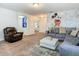 Inviting living room with custom Disney mural, plush seating, and a glimpse into a bright bedroom at 5255 Wildwood Way, Davenport, FL 33837