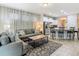 Open concept living room with access to the kitchen and featuring comfortable seating and stylish decor at 5255 Wildwood Way, Davenport, FL 33837