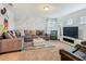 Cozy living room with playful Mickey Mouse themed wall, plush seating, and modern entertainment setup at 5255 Wildwood Way, Davenport, FL 33837