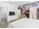 Stylish primary bedroom with geometric accent wall, tile flooring, and walk in closet at 5255 Wildwood Way, Davenport, FL 33837