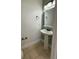 Half bath with pedestal sink, tiled floors and neutral wall color at 5515 Paradise Cay Cir, Kissimmee, FL 34746