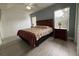 Comfortable bedroom featuring wood floors, a ceiling fan, and large windows for natural light at 5515 Paradise Cay Cir, Kissimmee, FL 34746