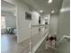 Upstairs hallway showing staircase, bedrooms and overhead lighting at 5515 Paradise Cay Cir, Kissimmee, FL 34746