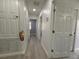 Bright hallway with new floors, fresh paint, multiple doorways, and ample lighting at 5515 Paradise Cay Cir, Kissimmee, FL 34746