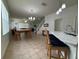 Bright and open living space featuring tile floors, dining area, and staircase at 5515 Paradise Cay Cir, Kissimmee, FL 34746