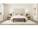 Bright bedroom featuring a bed with neutral bedding, decorative pillows, side tables and natural light at 5656 Vinyasa Rd, Clermont, FL 34714