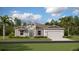 Charming single-story home with stone accents, lush lawn, attached two-car garage and manicured landscaping at 5656 Vinyasa Rd, Clermont, FL 34714