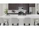 Modern kitchen featuring an island with white countertops, stainless steel appliances, and dark brown cabinets at 5656 Vinyasa Rd, Clermont, FL 34714