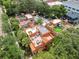 Overhead view of a group of homes with patios, red tile roofs, and surrounded by lush trees at 602 E Livingston St # 3, Orlando, FL 32803