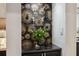 Stylish bar area with designer wallpaper, glass shelves, and dark countertop at 602 E Livingston St # 3, Orlando, FL 32803