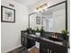 Bathroom features double sink vanity with black cabinets and granite countertop at 602 E Livingston St # 3, Orlando, FL 32803