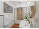 Bathroom features a tub, decorative mirror, white orchids, and modern fixtures at 602 E Livingston St # 3, Orlando, FL 32803