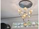 Modern chandelier with unique leaf-shaped elements and spherical lights against a white ceiling at 602 E Livingston St # 3, Orlando, FL 32803