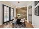 Elegant dining area featuring a round table, modern lighting, designer wallpaper and gated archway at 602 E Livingston St # 3, Orlando, FL 32803