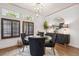 Elegant dining room with a glass-top table, velvet chairs, and designer lighting at 602 E Livingston St # 3, Orlando, FL 32803