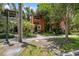 Two-story home with terracotta-colored exterior, lush landscaping, and a welcoming front walkway at 602 E Livingston St # 3, Orlando, FL 32803
