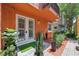 Stylish condo complex featuring a private entrance, walkway, and decorative landscaping at 602 E Livingston St # 3, Orlando, FL 32803