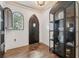 Elegant foyer with dark wood floors, unique display cabinet, and a striking arched window at 602 E Livingston St # 3, Orlando, FL 32803